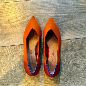 Rust orange Rothy’s pointed toe flats, size 10.5